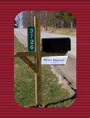 Example of a reflective address sign mounted beside a mailbox